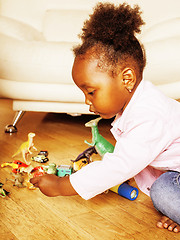 Image showing little cute african american girl playing with animal toys at ho