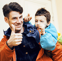 Image showing young handsome father with his son fooling around at home, lifes