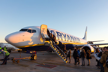 Image showing People boarding on Ryanair Jet commercial airplane on Valencia airport at sunset.