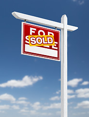 Image showing Left Facing Sold For Sale Real Estate Sign on a Blue Sky with Cl