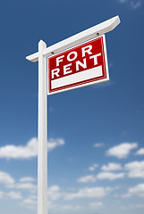 Image showing Right Facing For Rent Real Estate Sign on a Blue Sky with Clouds