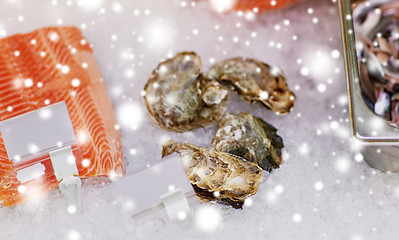 Image showing salmon fish and oysters on ice at grocery stall