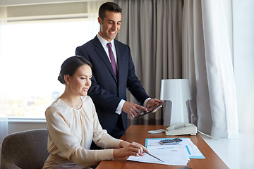 Image showing business team with papers working at hotel room