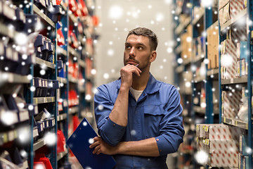 Image showing auto mechanic with clipboard at car workshop