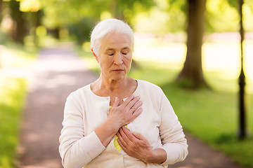 Image showing senior woman feeling sick at summer park