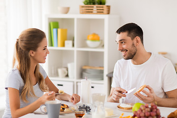 Image showing happy couple having breakfast at home