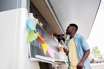 Image showing african american man with drink at food truck