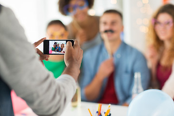 Image showing friends or coworkers photographing at office party