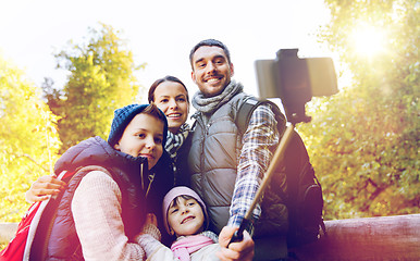 Image showing family with backpacks taking selfie and hiking