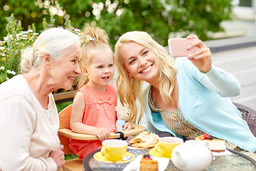 Image showing happy family taking selfie at cafe