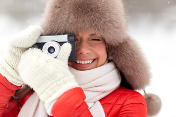 Image showing happy woman with film camera outdoors in winter