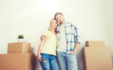 Image showing smiling couple with big boxes moving to new home