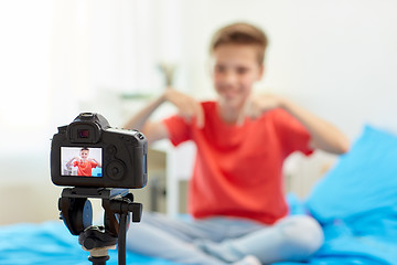 Image showing camera recording video of blogger boy at home