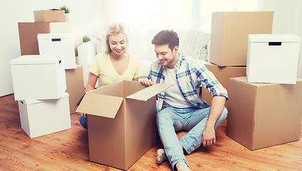 Image showing smiling couple with big boxes moving to new home