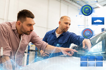 Image showing auto mechanic with clipboard and man at car shop