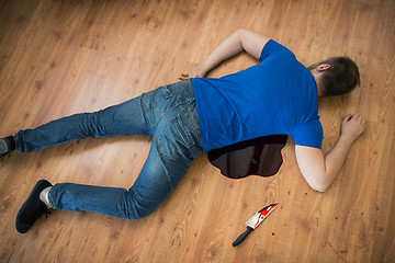 Image showing dead man body lying on floor at crime scene