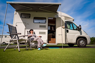 Image showing Woman resting near motorhomes in nature. Family vacation travel,