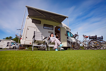 Image showing Woman resting near motorhomes in nature. Family vacation travel,