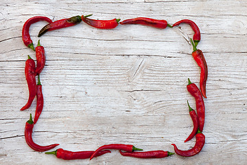 Image showing frame with pepper on wood background