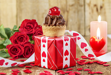 Image showing Cupcake with cherry over red gift box