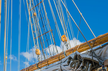 Image showing Folded sail and mast on an old sailboat