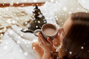 Image showing close up of happy woman with cup of cocoa at home