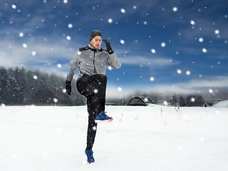 Image showing man exercising and warmig up in winter outdoors