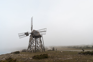 Image showing Old windmill in a misty landscape