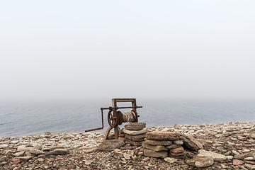 Image showing Old boat winch by the coast