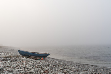 Image showing Lone landed rowboat by seaside