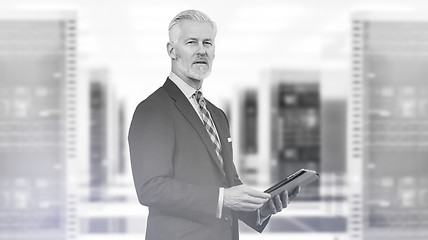 Image showing Senior businessman in server room