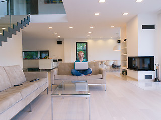 Image showing Young woman using laptop at home