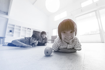 Image showing boys having fun with an apple on the floor