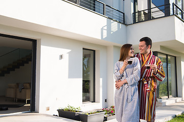 Image showing Young beautiful couple in bathrobes