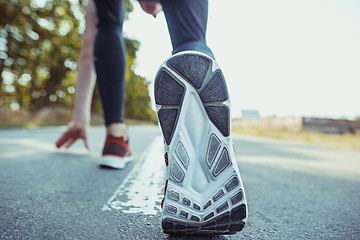 Image showing Running sport. Man runner sprinting outdoor in scenic nature. Fit muscular male athlete training trail running for marathon run.