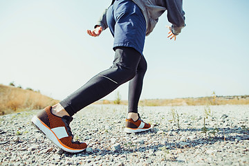 Image showing Running sport. Man runner sprinting outdoor in scenic nature. Fit muscular male athlete training trail running for marathon run.