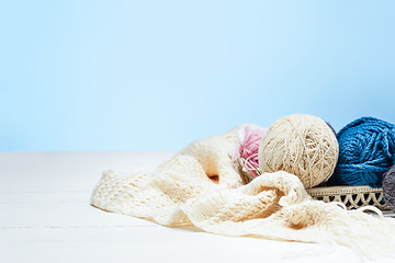 Image showing The balls of wool on white wooden background