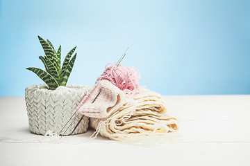 Image showing The balls of wool on white wooden background