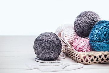 Image showing The balls of wool on white wooden background