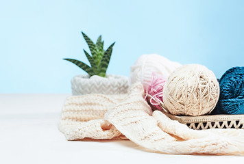 Image showing The balls of wool on white wooden background