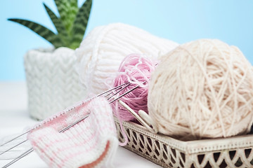 Image showing The balls of wool on white wooden background