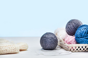 Image showing The balls of wool on white wooden background