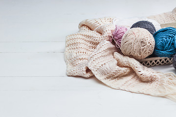 Image showing The balls of wool on white wooden background