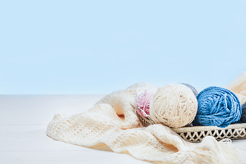 Image showing The balls of wool on white wooden background