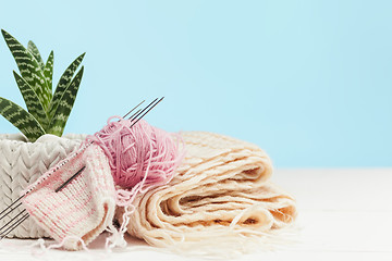 Image showing The balls of wool on white wooden background