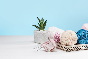 Image showing The balls of wool on white wooden background