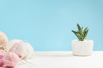 Image showing The balls of wool on white wooden background