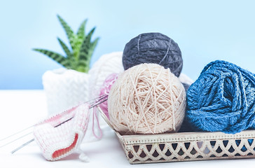 Image showing The balls of wool on white wooden background