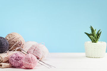 Image showing The balls of wool on white wooden background