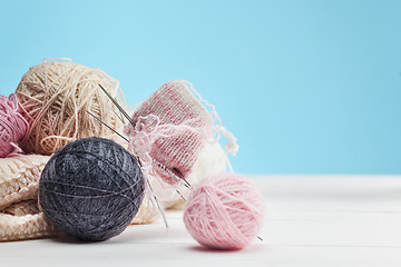 Image showing The balls of wool on white wooden background